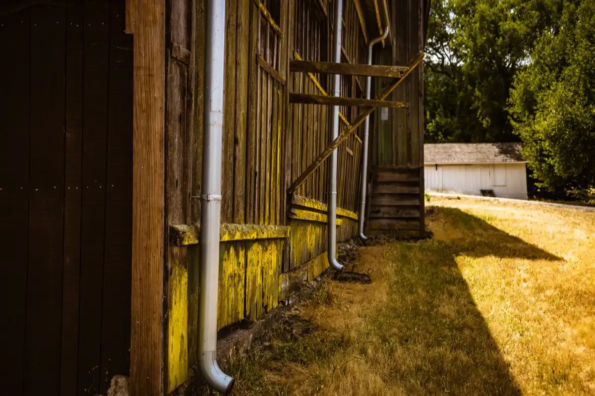 Roof edge, fascia and downspout on a house in Peoria, IL, where drip edge carries runoff into the gutter